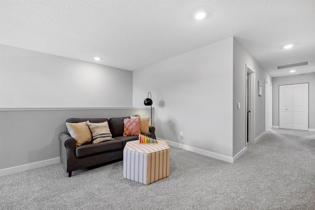 living room featuring recessed lighting, baseboards, a textured ceiling, and carpet flooring