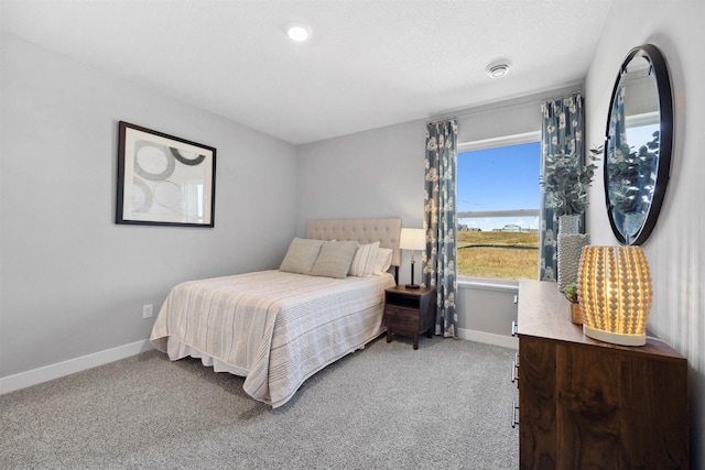 carpeted bedroom featuring baseboards