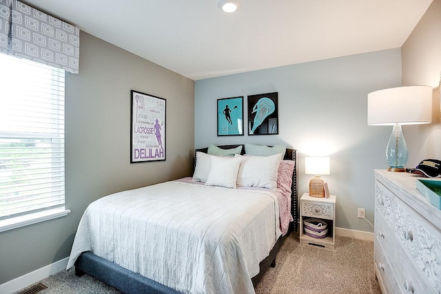 carpeted bedroom featuring visible vents and baseboards