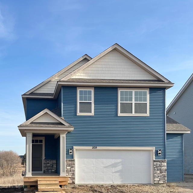 view of front of home featuring stone siding and an attached garage