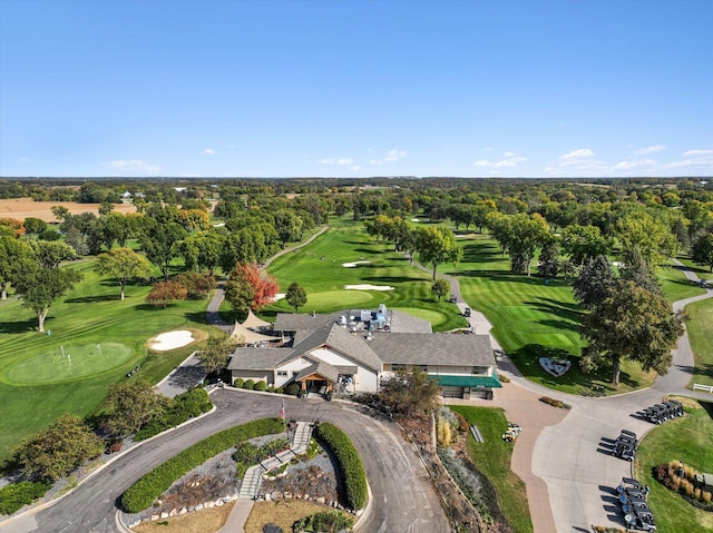 bird's eye view featuring a wooded view and view of golf course