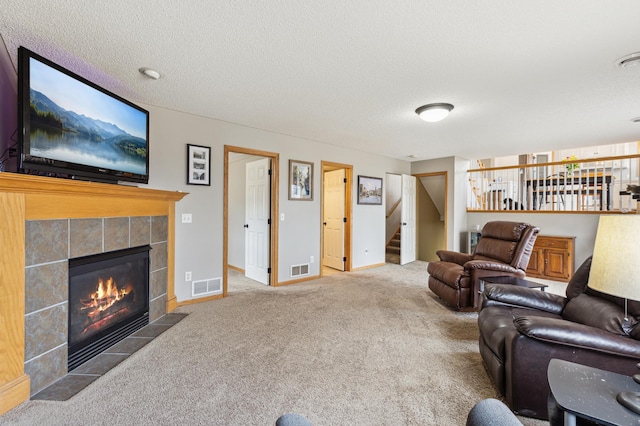 2316 Coldwater Xing, Mayer, MN 55360 - carpeted living room featuring stairway, a tile fireplace, and baseboards