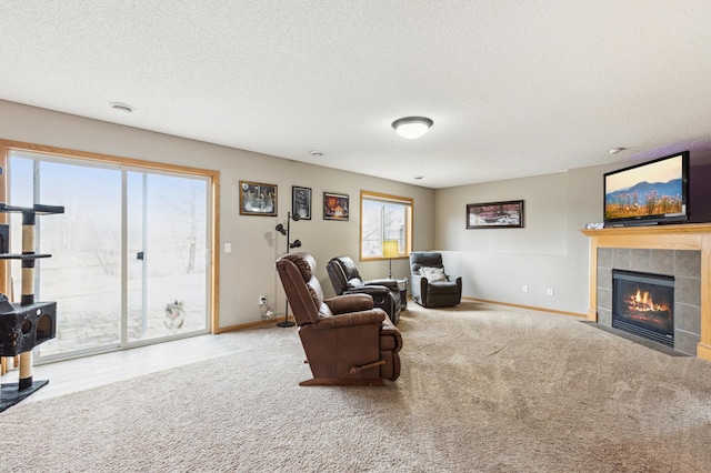2316 Coldwater Xing, Mayer, MN 55360 - living room with baseboards, carpet floors, a textured ceiling, and a tiled fireplace