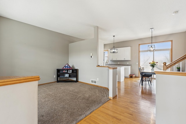 2316 Coldwater Xing, Mayer, MN 55360 - interior space with light wood finished floors, baseboards, stairway, and a chandelier