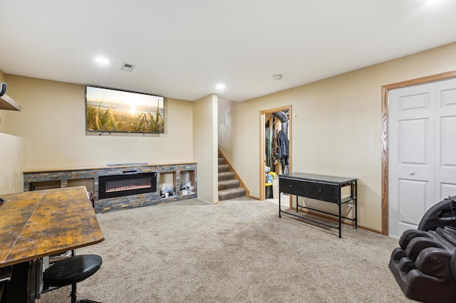 2316 Coldwater Xing, Mayer, MN 55360 - carpeted living area with a glass covered fireplace, stairs, recessed lighting, and baseboards
