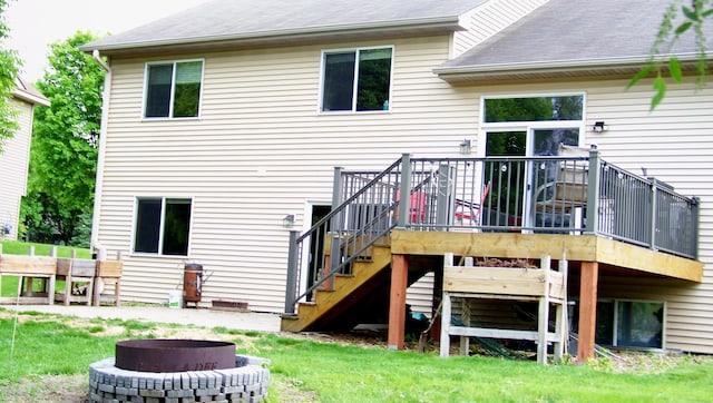 2316 Coldwater Xing, Mayer, MN 55360 - back of property featuring an outdoor fire pit, stairs, a wooden deck, roof with shingles, and a lawn