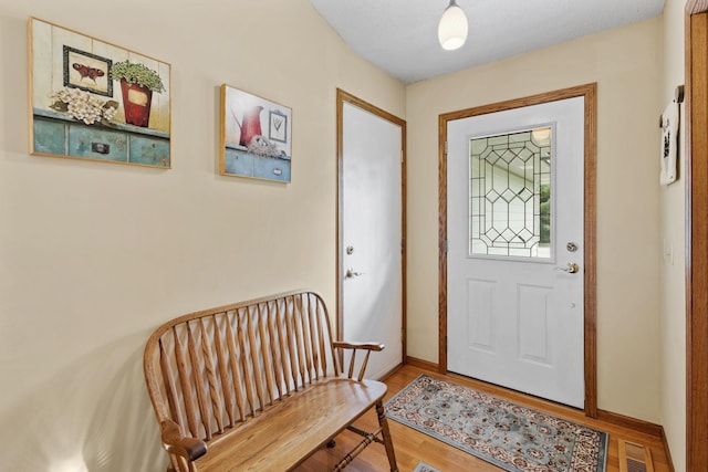 entrance foyer featuring visible vents, baseboards, and wood finished floors