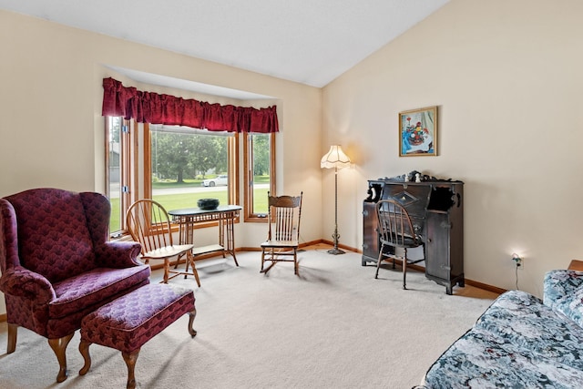 sitting room featuring baseboards, carpet, and vaulted ceiling