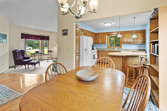 dining space with a notable chandelier and light wood-style floors