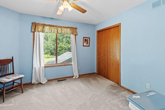 carpeted bedroom with baseboards, visible vents, and a closet