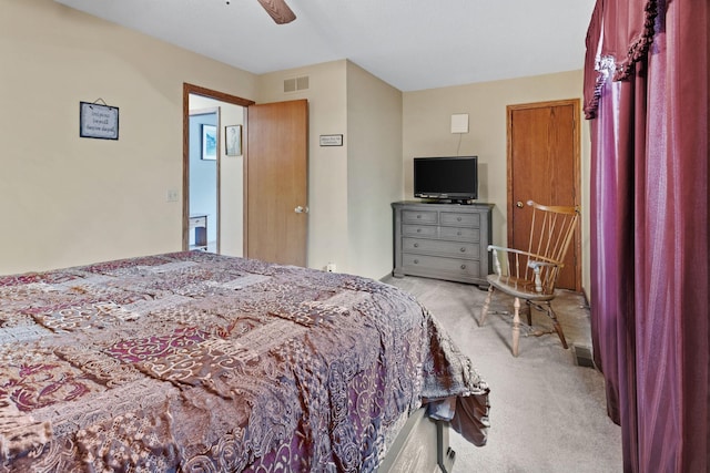 bedroom with a ceiling fan, light colored carpet, and visible vents