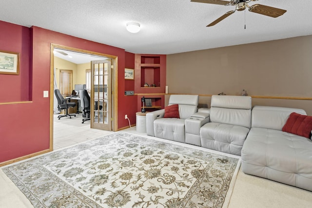 living area with a textured ceiling and ceiling fan