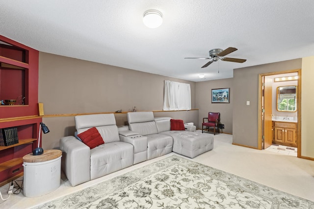 living room featuring a textured ceiling, ceiling fan, and carpet floors