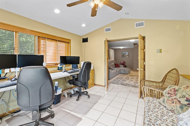 home office featuring light tile patterned flooring, visible vents, a ceiling fan, and vaulted ceiling