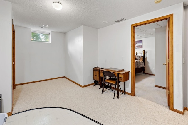 interior space with visible vents, a textured ceiling, and baseboards