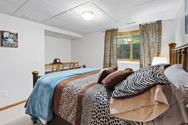 bedroom with visible vents, a paneled ceiling, baseboards, and carpet floors