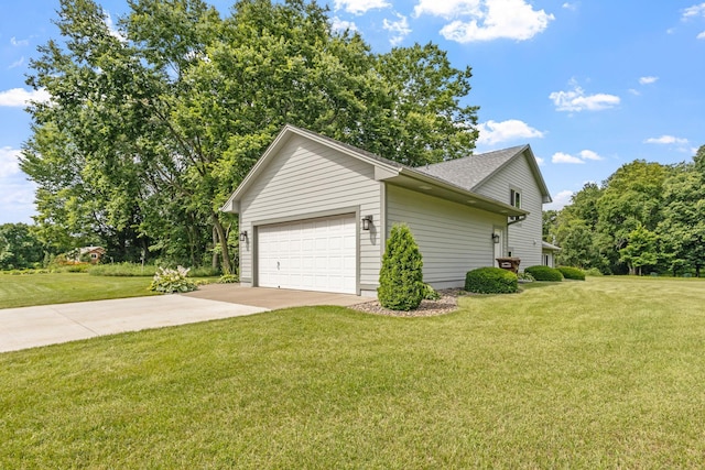 view of side of home featuring a yard, concrete driveway, and an attached garage