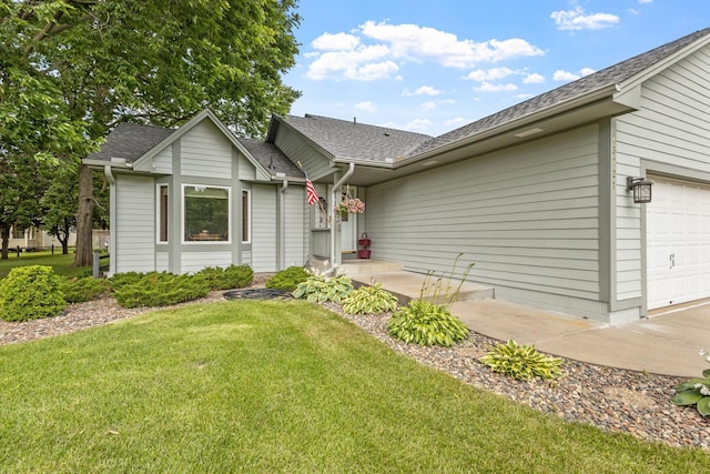 single story home featuring an attached garage, a front lawn, and roof with shingles