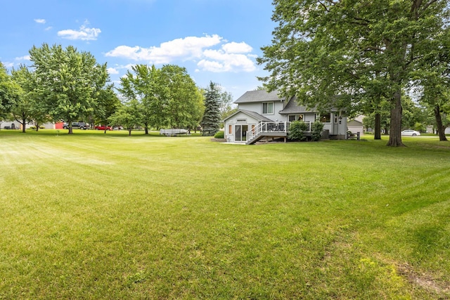 view of yard featuring a wooden deck