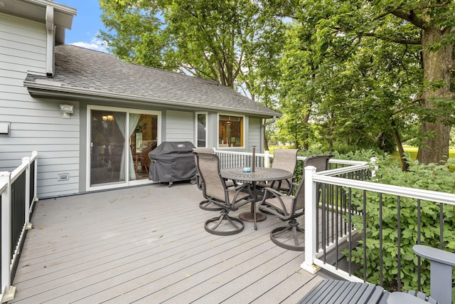 deck featuring grilling area and outdoor dining space