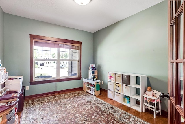 recreation room with baseboards