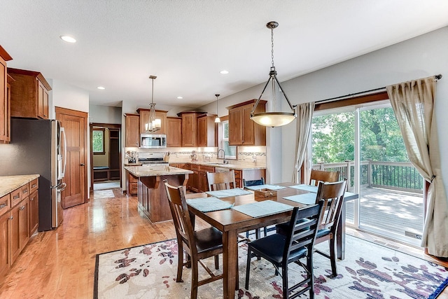 dining space featuring light wood finished floors and recessed lighting