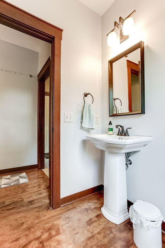 bathroom featuring wood finished floors and baseboards