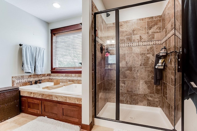 bathroom featuring a shower stall and a garden tub