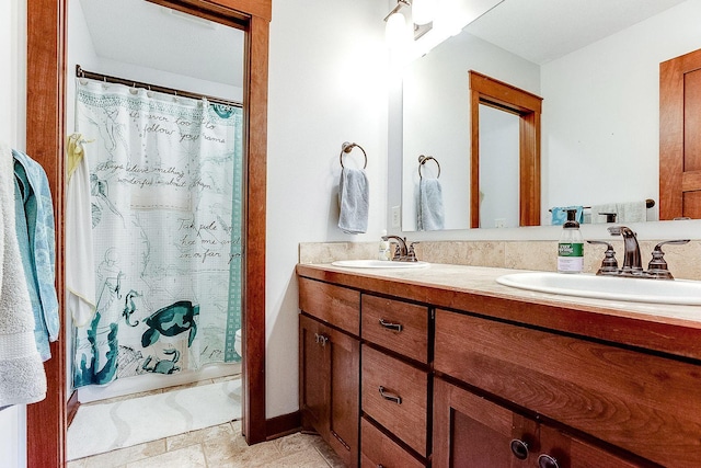 bathroom with a sink, a shower with shower curtain, and double vanity