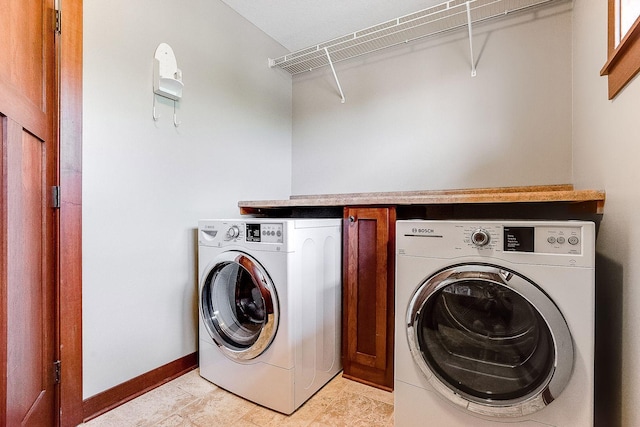 laundry room featuring baseboards, laundry area, and washing machine and clothes dryer