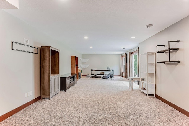 living room featuring light carpet, recessed lighting, and baseboards