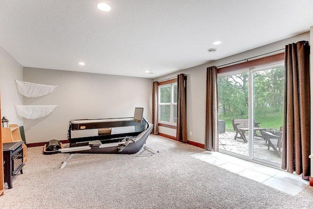 exercise room featuring carpet flooring, recessed lighting, and baseboards