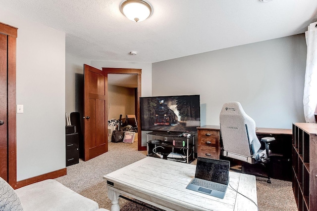 office area with baseboards, a textured ceiling, and carpet