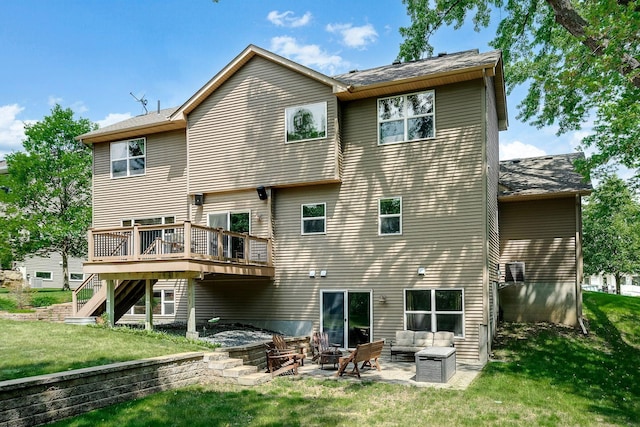 rear view of property featuring a lawn, an outdoor living space with a fire pit, a wooden deck, stairs, and a patio area