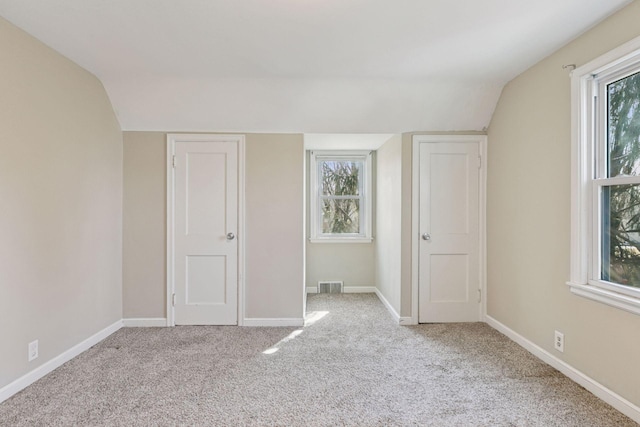 unfurnished bedroom with visible vents, multiple windows, and baseboards