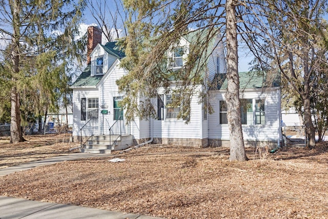 new england style home with a chimney and fence