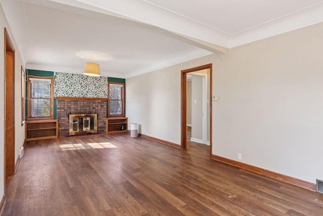 unfurnished living room with visible vents, baseboards, ornamental molding, a fireplace, and wood finished floors