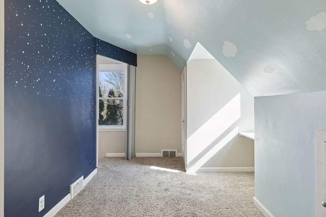 bonus room featuring baseboards, visible vents, carpet floors, and lofted ceiling