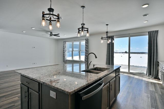 kitchen featuring decorative light fixtures, dishwashing machine, dark wood-type flooring, and a sink