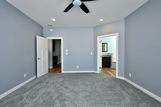 unfurnished bedroom with ensuite bath, recessed lighting, carpet flooring, baseboards, and ceiling fan