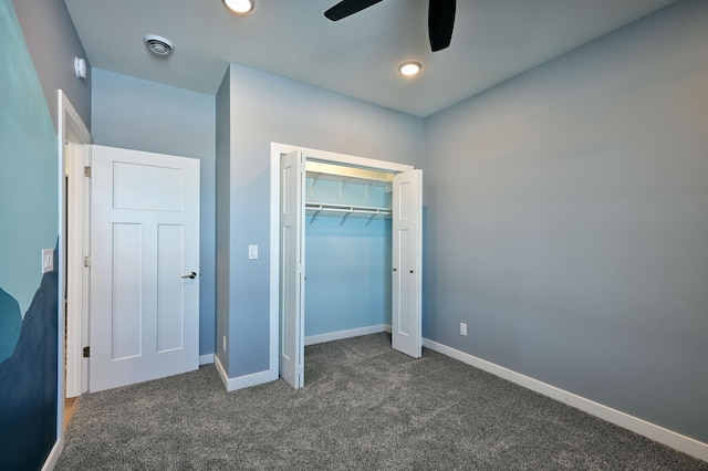 unfurnished bedroom featuring a closet, visible vents, dark carpet, and baseboards