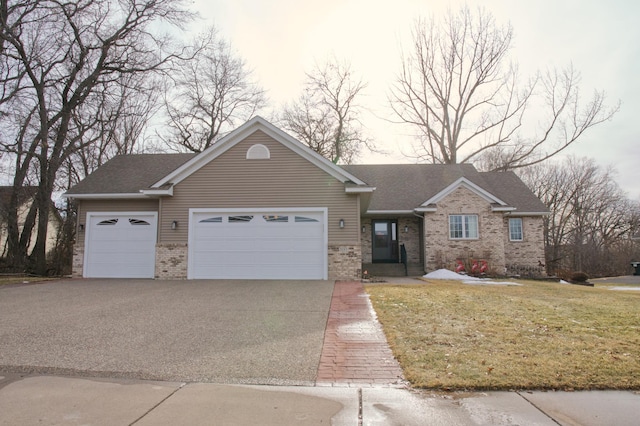 view of front of home featuring a front lawn, brick siding, a garage, and driveway