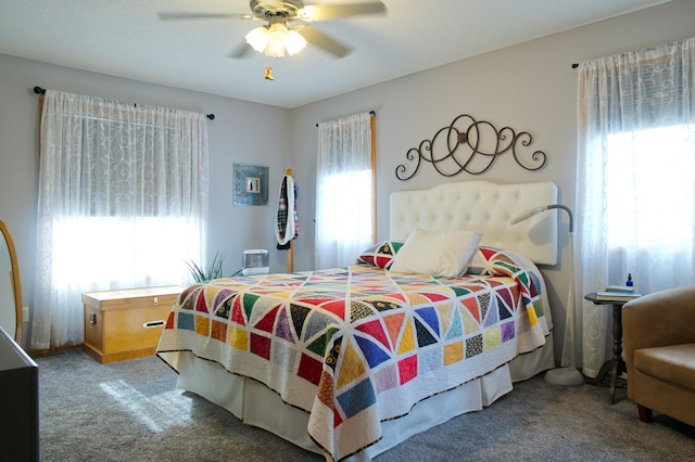 bedroom with carpet flooring, multiple windows, and ceiling fan