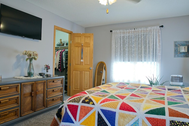 bedroom with a spacious closet, a closet, and carpet floors