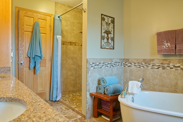 bathroom featuring double vanity, a tile shower, a sink, tile walls, and a washtub