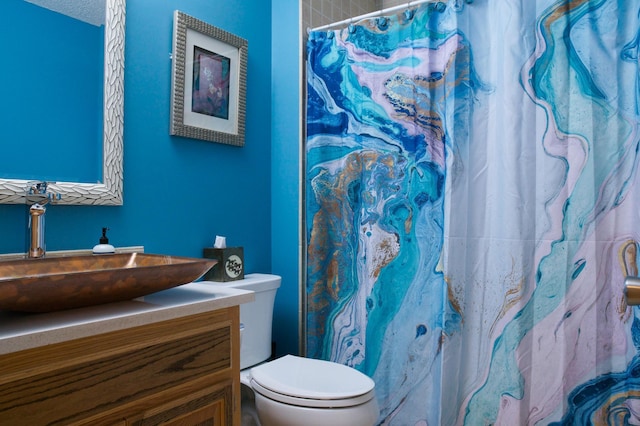 bathroom featuring vanity, toilet, and a shower with curtain