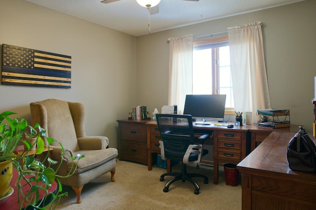 home office with light carpet and a ceiling fan