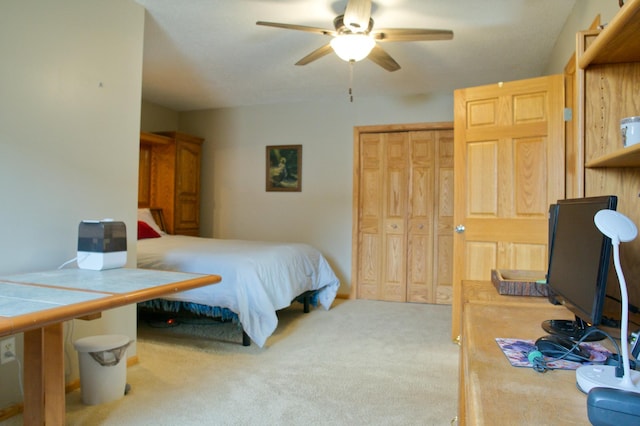 carpeted bedroom with a closet and a ceiling fan