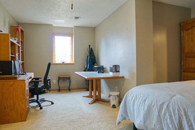 carpeted bedroom featuring baseboards, visible vents, and a textured ceiling