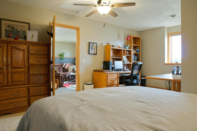 bedroom with visible vents, a textured ceiling, and carpet